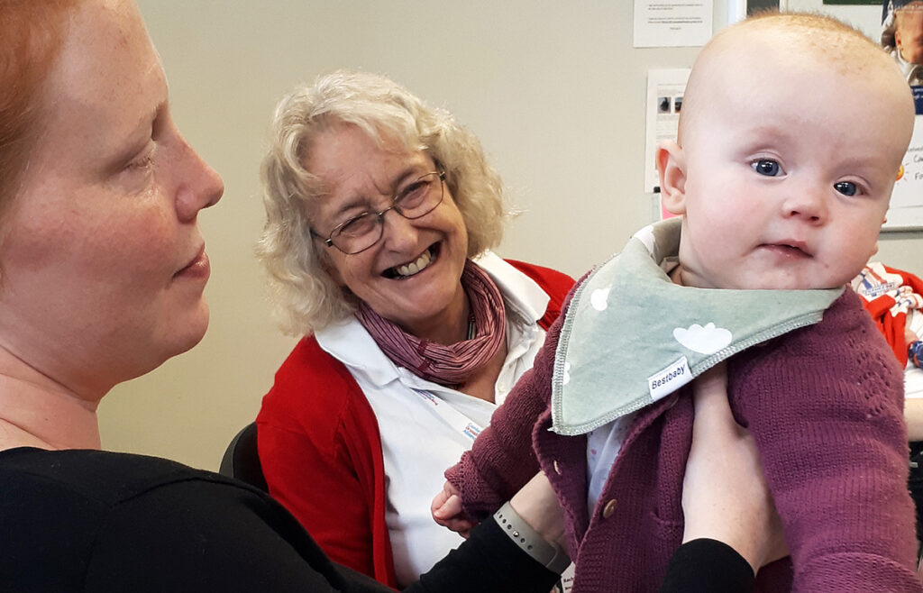 Photo of mum and baby with breastfeeding counsellor at the Cambridge drop-in.
